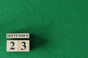 September 23, number cube on snooker table, sport background.