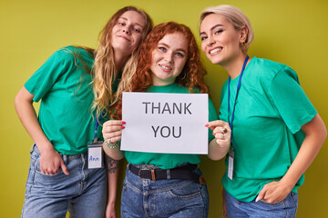 three caucasian women say thanks to people participating in charity, volunteering. beautiful ladies...