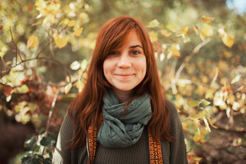 Young woman portrait looking at the camera in the forest