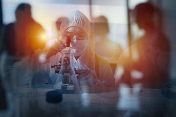 Doctor in the laboratory analyzes samples under a microscope. Pharmaceutical treatment concept.