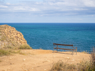 Fototapeta na wymiar bench near seashore with view over the sea