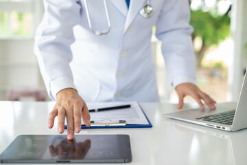 Doctor using digital tablet find information patient medical history at the hospital. Medical...