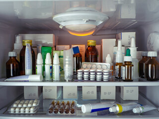 Medicines for various diseases, in various packages, are placed on the shelves of the refrigerator....
