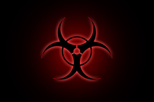 Biohazard sign on black background in red glow