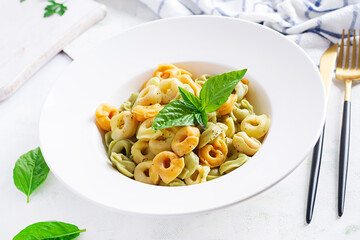 Italian ravioli pasta with spinach and ricotta in white plate. Italian tortellini pasta.