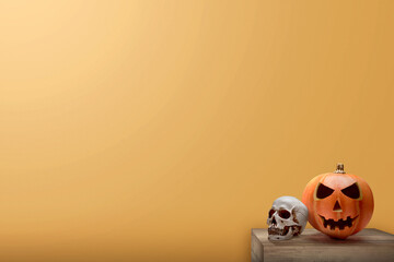 Jack-o-Lantern and human skull on the table