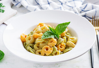 Italian ravioli pasta with spinach and ricotta in white plate. Italian tortellini pasta.