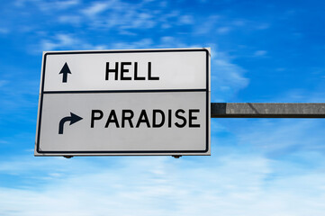 White road sign with words hell and paradise against blue sky background.