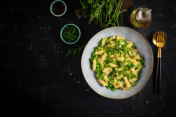 Vegan salad. Fusilli pasta with green peas and onions. Italian food. Top view. Flat lay.