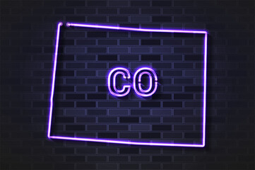 Fototapeta premium Colorado map glowing neon lamp or glass tube on a black brick wall