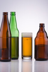 beautiful graceful variety of glass bottles and a glass of beer