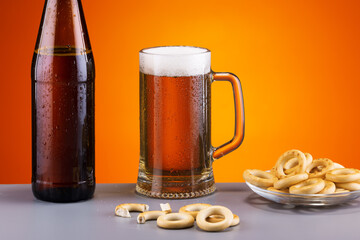cold frothy beer with bread bagels drying