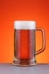 fresh aromatic beer with foam in an elegant glass mug