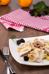 delicious fresh salad with chicken and croutons decorated with blackberries