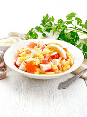 Salad of surimi and tomatoes with eggs on board