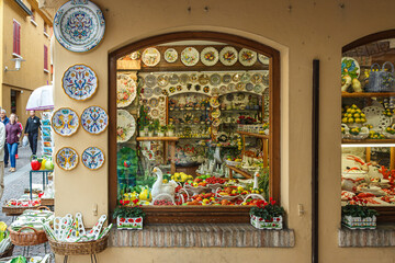 The showcase of a souvenir shop selling porcelain decorative items in the Sirmione town in...