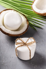 Handmade natural herbal coconut oil soap white color on grey concrete background.