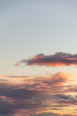 Evening sky with rain clouds in orange-pink sunset light