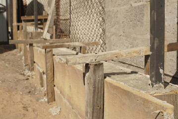 Fototapeta na wymiar Wooden Formwork Concrete Strip Foundation For A Fence