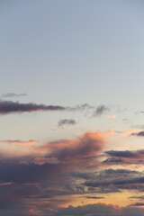 Evening sky with rain clouds in orange-pink sunset light