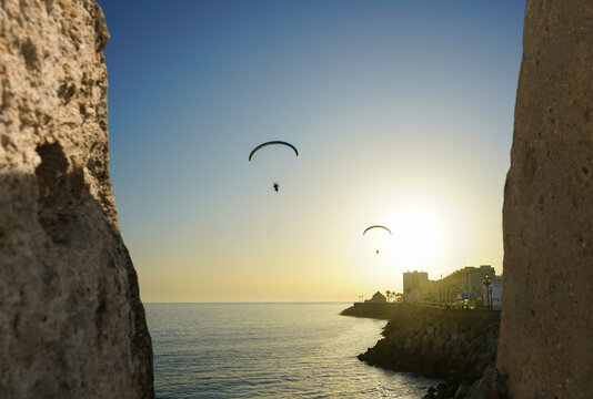 Two paragliders in C&aacute;diz sky on sunset time, Andalusia, Spain