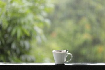 White coffee on balcony railing frame on rainy day 