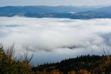 sunrise over the mountains with clouds and fog