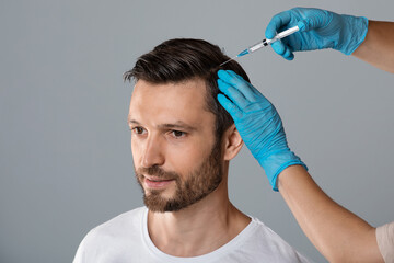 Mesotherapy for hair. Man receiving injections in head