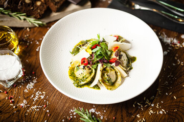 Black Angus hand-made dumplings. Cucumber-julienne with chilli-garlic butter or beef stock with sour cream. Delicious meat food closeup served on a table for lunch in modern cuisine gourmet restaurant