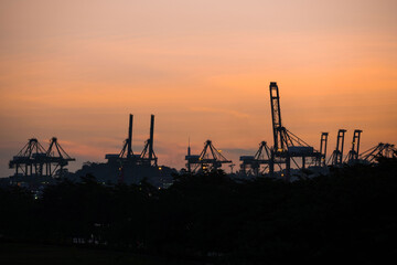 Container cranes at Singapore Cargo Terminals at sunset