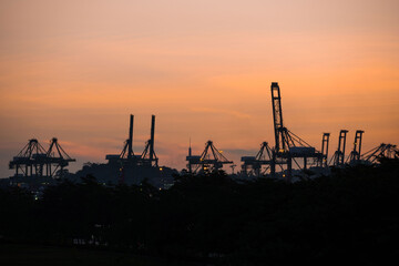 Fototapeta premium Container cranes at Singapore Cargo Terminals at sunset