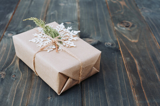 String Or Twine Tied In A Bow On Kraft Paper. Beown Gift Box On Wood With Space.