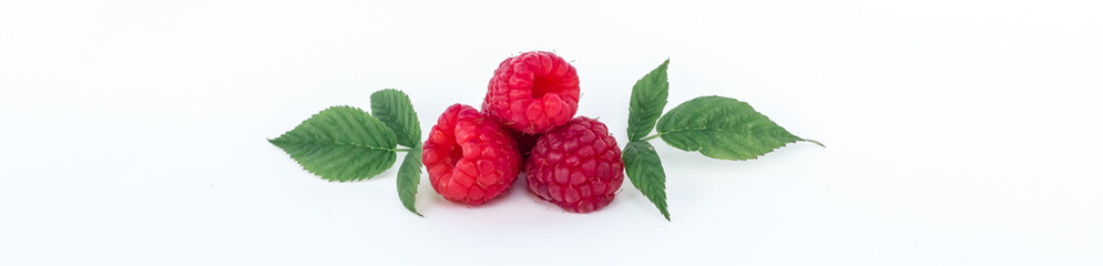 Ripe fresh natural raspberries with green leaves close-up on a white background