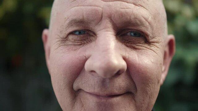 Portrait of mature man. Pensive looking and smiling. Senior looking at the camera and smiling.