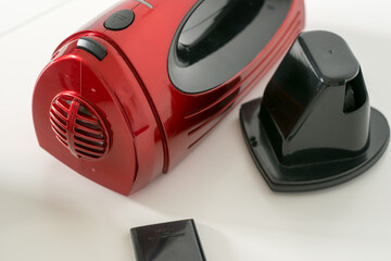 Close-up view of a red car vacuum cleaner taken apart - obrazy, fototapety, plakaty