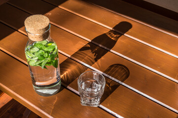 Water bottle and a glass on a wooden table