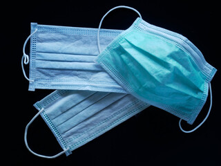 Medical protective mask on blue background. Disposable surgical face mask cover the mouth and nose.