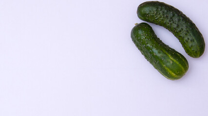 Young green cucumbers on a white background
