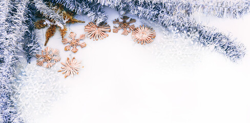 Beautiful Christmas background and lots of empty space for lettering and design. Shiny silver Christmas tinsel and artificial stars and snowflakes, Christmas toys.