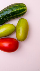 Cucumber, green and red tomatoes, close-up white background