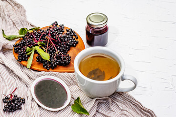 Elderberry jam from ripe berries and hot tea