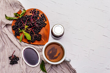 Elderberry jam from ripe berries and hot tea