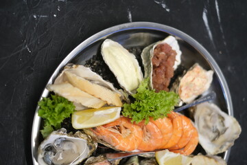 a plate of assorted seafood on a white background close-up