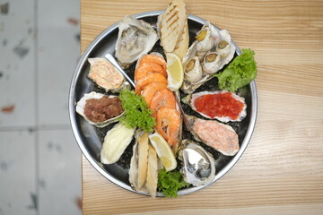a plate of assorted seafood on a white background in top view