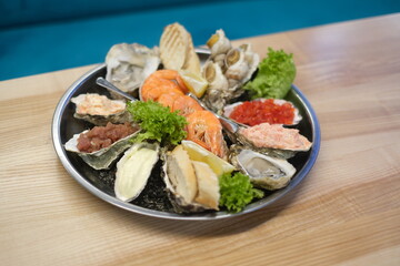 a plate of assorted seafood on a white background in top view