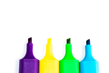 Standard set of four colorful markers on white paper.