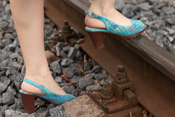 pedestrian in heels across the train tracks
