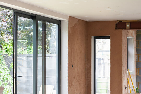 Property extension renovation, plastering of the walls, undercoat layer. Unfinished walls and ceilings, selective focus