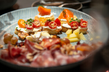 close up of bruschetta on variety of  italian cold cut board