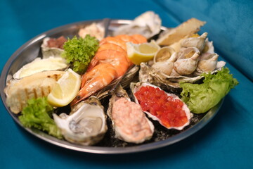 a plate of assorted seafood on a blue background in top view
